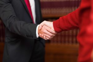 Photo of a businessman giving a handshake to a customer