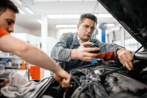 Photo of car mechanics working and maintaining car